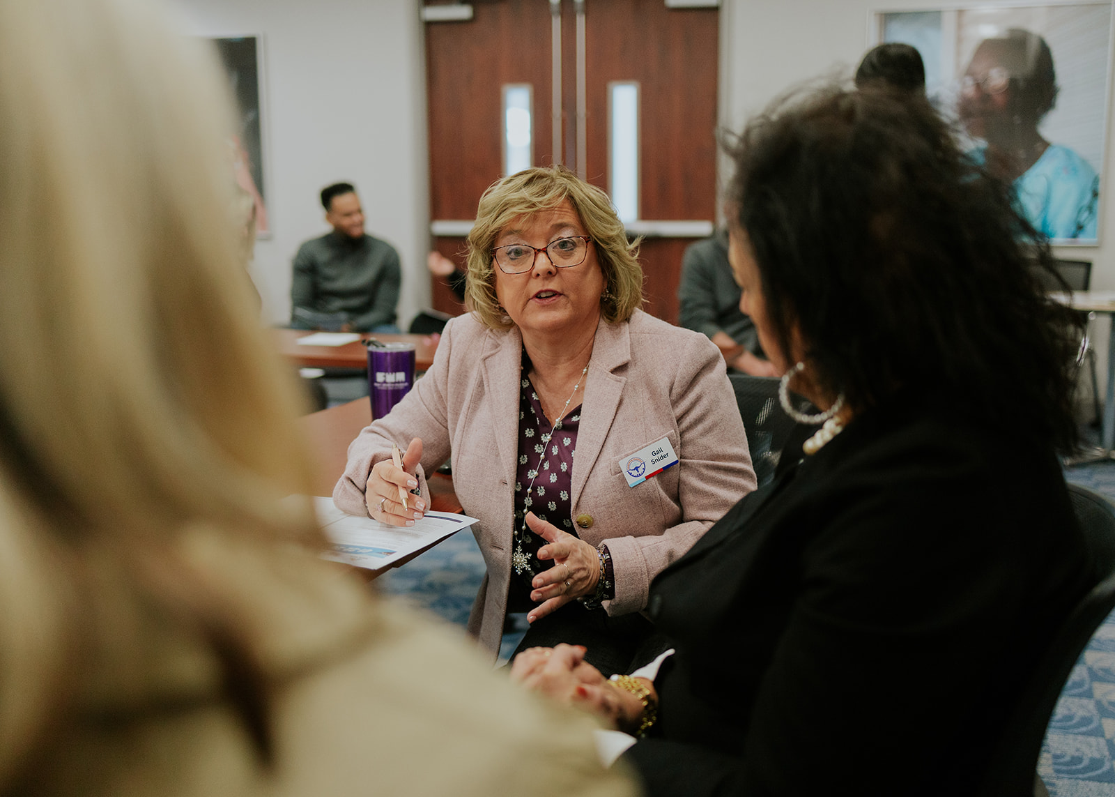 A nonprofit leader speaking during a small group discussion